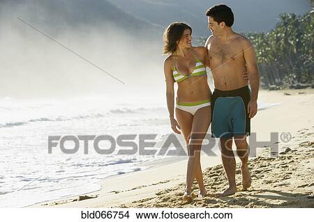 Picture - Couple hugging on beach. Fotosearch