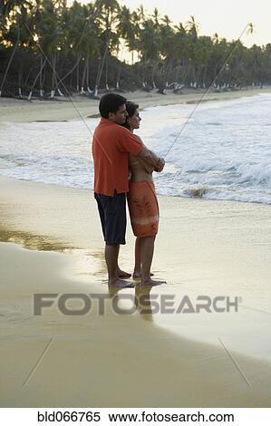 Stock Photography - Couple hugging on beach. Fotosearch
