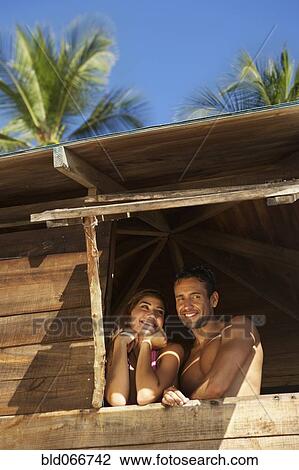 Stock Image - Couple in lifeguard tower. Fotosearch