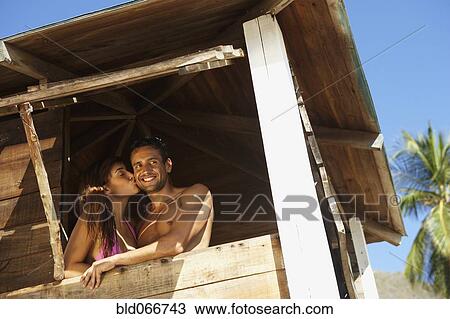 Stock Image - Couple in lifeguard tower. Fotosearch