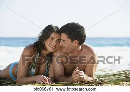 Couple laying on beach View Large Photo Image Stock Image - Couple laying on beach. Fotosearch