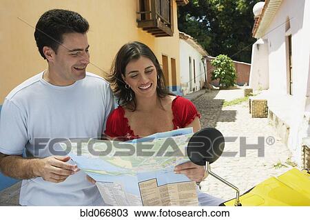 Stock Image - Couple looking at map. Fotosearch