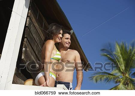 Stock Photo - Couple standing in lifeguard tower. Fotosearch