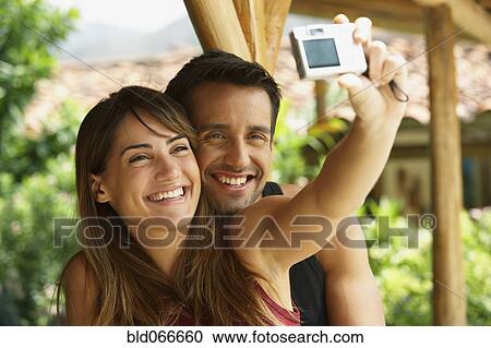 Couple taking self-portrait View Large Photo Image Stock Image - Couple taking self-portrait. Fotosearch