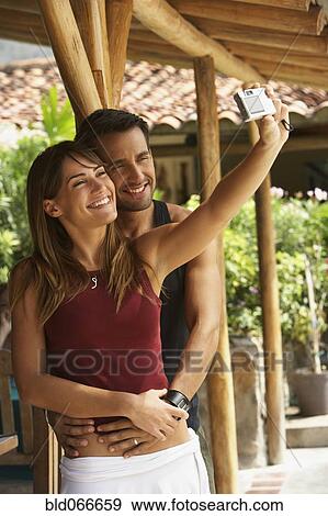 Couple taking self-portrait View Large Photo Image Stock Photo - Couple taking self-portrait. Fotosearch