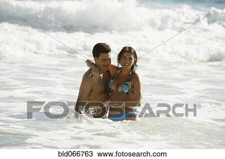 Couple wading in ocean View Large Photo Image Stock Image - Couple wading in ocean. Fotosearch