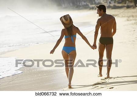 Couple walking on beach View Large Photo Image Stock Image - Couple walking on beach. Fotosearch