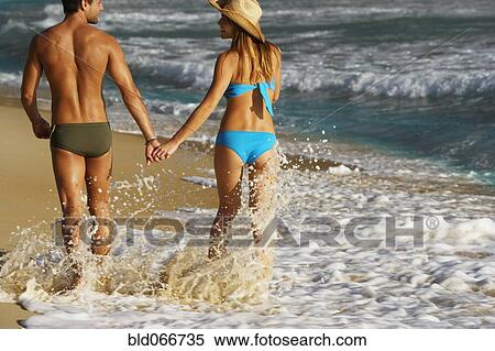 Couple walking on beach View Large Photo Image Stock Photography - Couple walking on beach. Fotosearch