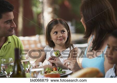 Stock Photo - Family enjoying healthy lunch. Fotosearch