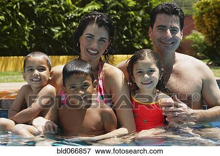 Stock Photo - Family swimming in swimming pool. Fotosearch