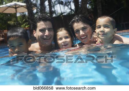Stock Photo - Family swimming in swimming pool. Fotosearch