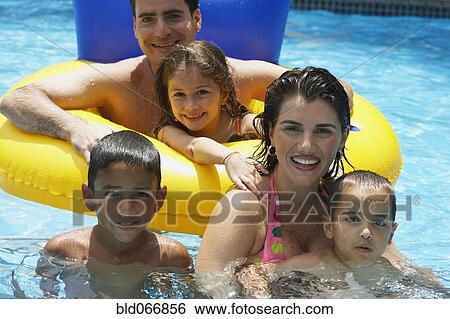 Family swimming in swimming pool View Large Photo Image Stock Photograph - Family swimming in swimming pool. Fotosearch