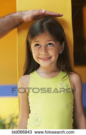 Father measuring daughter’s height View Large Photo Image Stock Image - Father measuring daughter’s height. Fotosearch