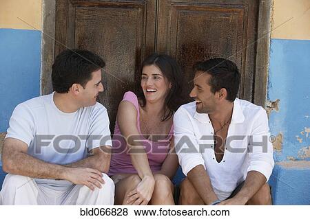 Stock Photo - Friends sitting and laughing. Fotosearch
