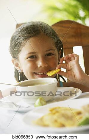 Girl eating soup for lunch View Large Photo Image Stock Image - Girl eating soup for lunch. Fotosearch