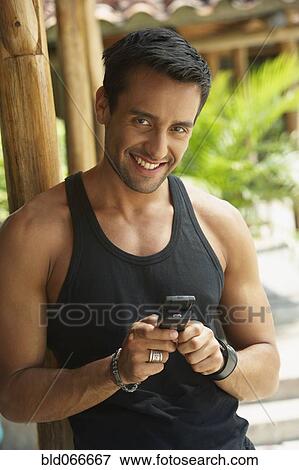 Happy man text messaging on cell phone View Large Photo Image Stock Photo - Happy man text messaging on cell phone. Fotosearch
