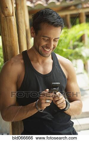 Happy man text messaging on cell phone View Large Photo Image Stock Photograph - Happy man text messaging on cell phone. Fotosearch