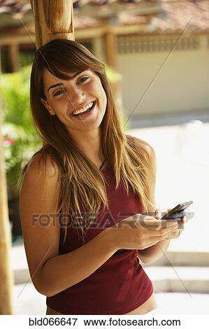 Happy woman texting on cell phone View Large Photo Image Stock Photo - Happy woman texting on cell phone. Fotosearch