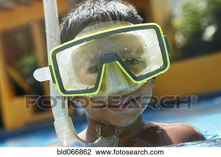 Stock Image - Hispanic boy in goggles and snorkel. Fotosearch