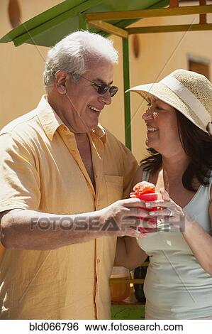 Hispanic couple drinking frozen drink View Large Photo Image Stock Photograph - Hispanic couple drinking frozen drink. Fotosearch