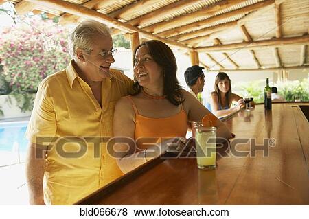 Hispanic couple drinking in bar View Large Photo Image Stock Photo - Hispanic couple drinking in bar. Fotosearch