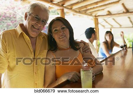 Stock Photo - Hispanic couple drinking in bar. Fotosearch