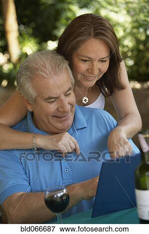 Hispanic couple drinking red wine in cafe View Large Photo Image Stock Photo - Hispanic couple drinking red wine in cafe. Fotosearch