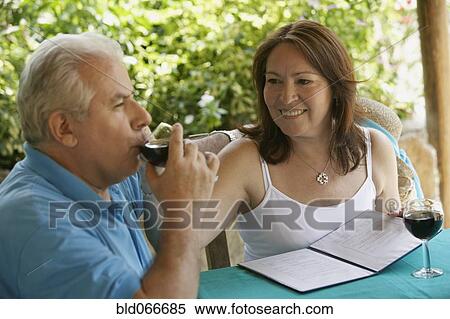 Hispanic couple drinking red wine in cafe View Large Photo Image Stock Photography - Hispanic couple drinking red wine in cafe. Fotosearch