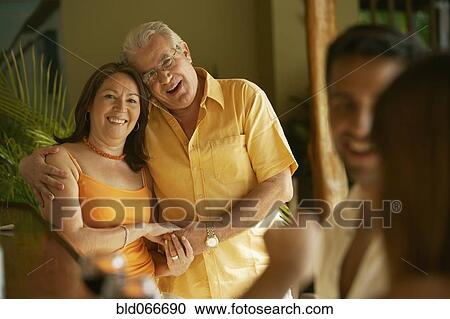 Stock Image - Hispanic couple hugging and smiling. Fotosearch