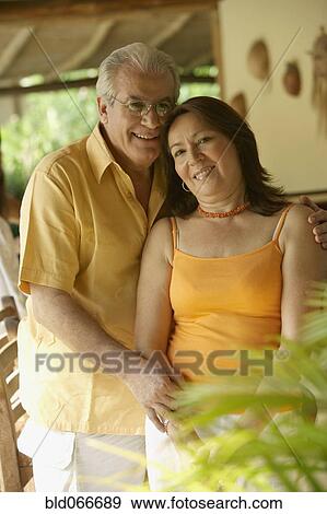 Stock Photo - Hispanic couple hugging and smiling. Fotosearch
