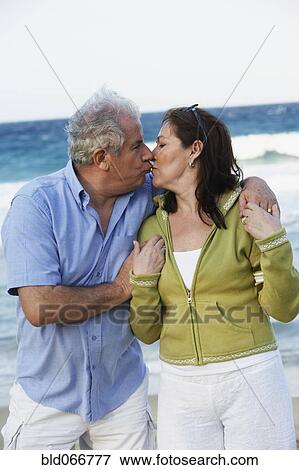 Hispanic couple kissing on beach View Large Photo Image Stock Photo - Hispanic couple kissing on beach. Fotosearch