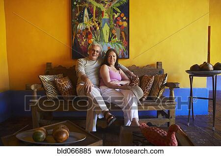 Hispanic couple sitting in living room View Large Photo Image Stock Photography - Hispanic couple sitting in living room. Fotosearch
