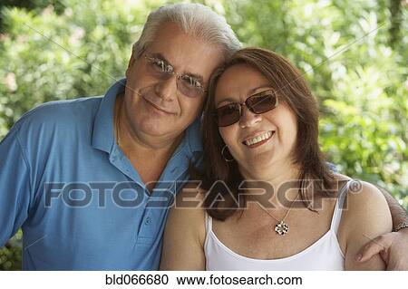 Stock Image - Hispanic couple smiling and hugging. Fotosearch
