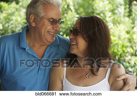 Hispanic couple smiling and hugging View Large Photo Image Stock Image - Hispanic couple smiling and hugging. Fotosearch