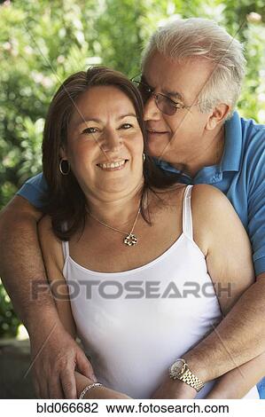 Hispanic couple smiling and hugging View Large Photo Image Stock Image - Hispanic couple smiling and hugging. Fotosearch
