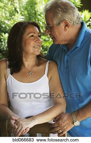 Stock Image - Hispanic couple smiling and hugging. Fotosearch