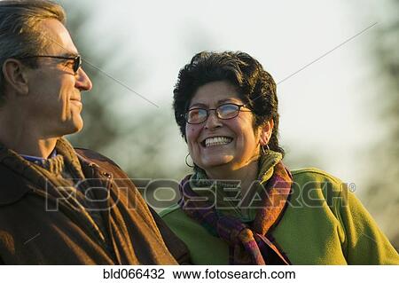 Stock Image - Hispanic couple smiling outdoors. Fotosearch