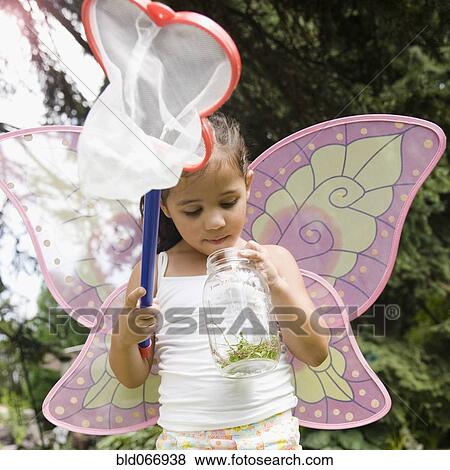 Stock Photo - Hispanic girl in butterfly costume with jar. Fotosearch