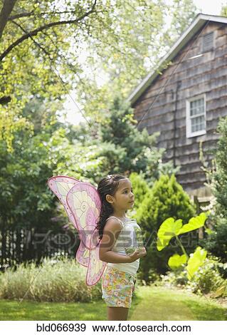 Hispanic girl in butterfly costume with jar View Large Photo Image Stock Photo - Hispanic girl in butterfly costume with jar. Fotosearch