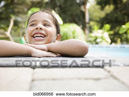 Hispanic girl resting at poolside View Large Photo Image Stock Photograph - Hispanic girl resting at poolside. Fotosearch
