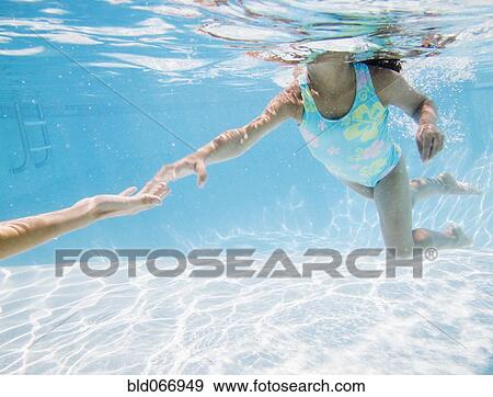 Stock Photo - Hispanic girl swimming in pool. Fotosearch