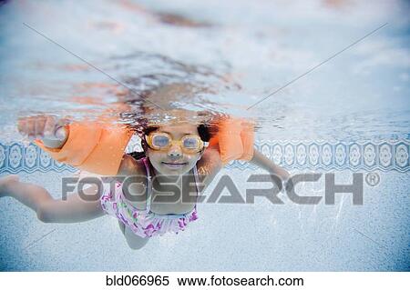 Hispanic girl swimming underwater in pool View Large Photo Image Stock Photography - Hispanic girl swimming underwater in pool. Fotosearch