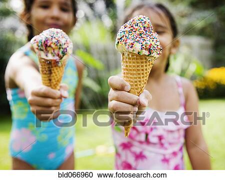 Hispanic girls eating ice cream cones View Large Photo Image Stock Image - Hispanic girls eating ice cream cones. Fotosearch