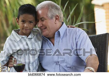 Hispanic grandfather hugging grandson View Large Photo Image Picture - Hispanic grandfather hugging grandson. Fotosearch
