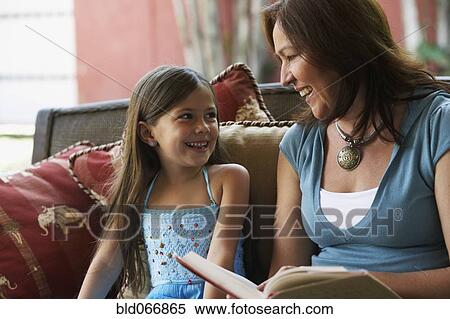 Hispanic grandmother reading to granddaughter View Large Photo Image Stock Photography - Hispanic grandmother reading to granddaughter. Fotosearch