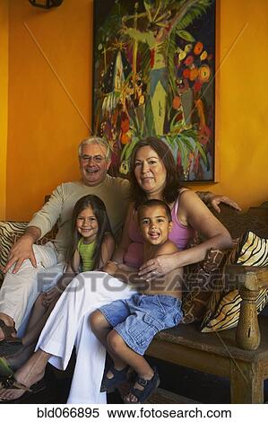 Stock Photography - Hispanic grandparents sitting with grandchildren. Fotosearch