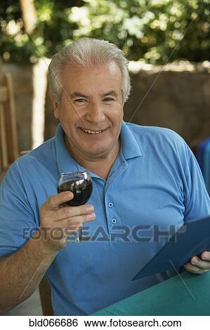 Hispanic man drinking red wine in cafe View Large Photo Image Stock Photograph - Hispanic man drinking red wine in cafe. Fotosearch