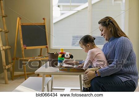 Picture - Hispanic mother and daughter doing art. Fotosearch