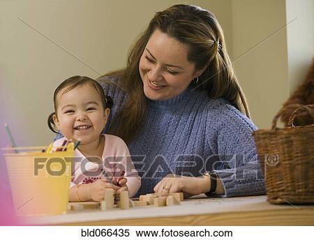 Stock Photography - Hispanic mother and daughter doing art. Fotosearch