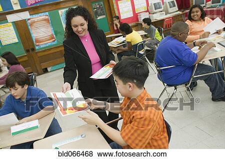 Hispanic school teacher presenting award to student View Large Photo Image Stock Photo - Hispanic school teacher presenting award to student. Fotosearch
